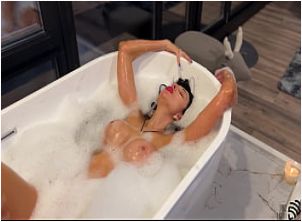 Porn star Liza Virgin takes a bath while being watched